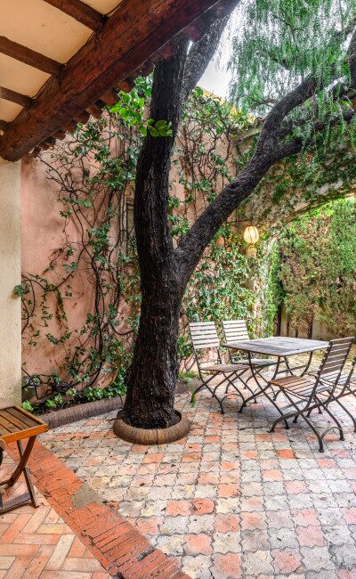 Patio d'ingresso ombreggiato sotto un falso pepe, atmosfera mediterranea a Cimiez
